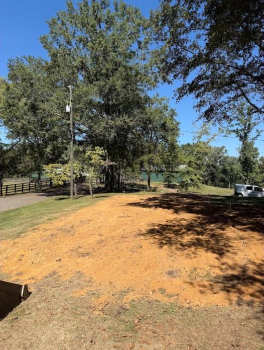 Cleared orange soil in a yard for Precision Services.